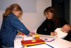 Une petite fille fait ses devoirs avec sa belle-mère.